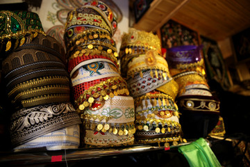 East skullcap in souvenir shop market. Selective focus 