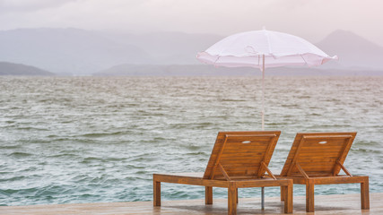 two chairs and umbrella on the beach