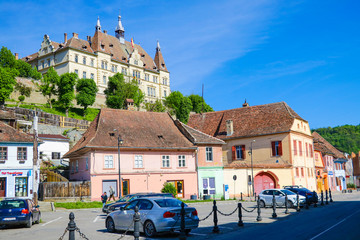 Sighisoara, Romania, May 11, 2019: Beautiful colorful street in Sighisoara in typical traditional...