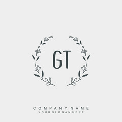 letter GT surrounded by beautiful and elegant flowers and leaves. Wedding monogram logo template.