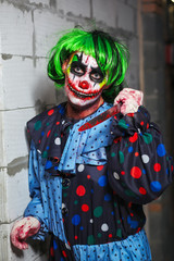 Fototapeta na wymiar Crazy clown with a knife. Halloween concept