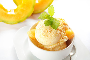 Fresh melon ice cream with melon and melissa  on white background 