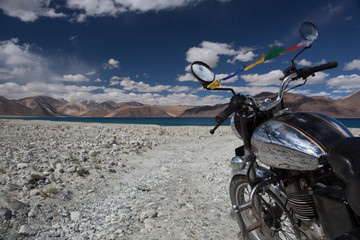 Travelling by bike along high altitude Pangong lake in Ladakh, India. - obrazy, fototapety, plakaty