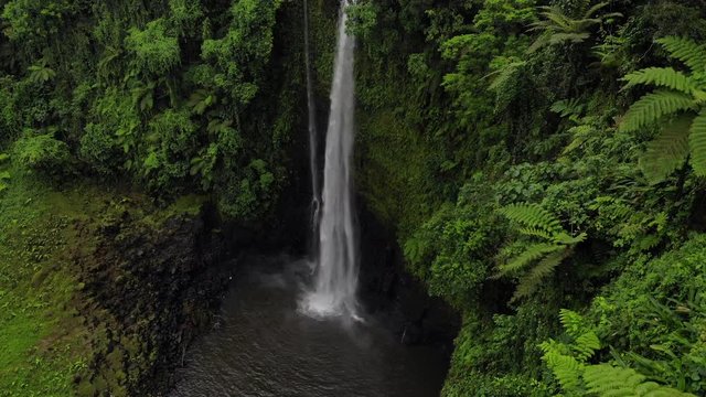 Aerial shot rising alongside Fuipisia Waterfall in Western Samoa