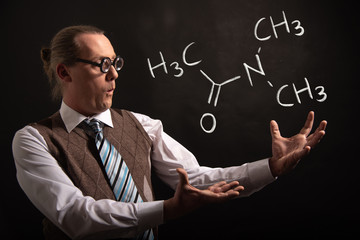 Professor presenting handdrawn chemical formula of Dimethylacetamide