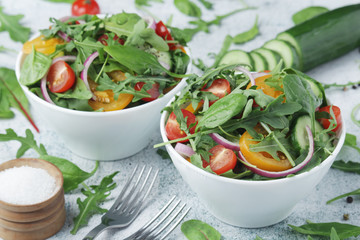 Two bowls full of vegetable salad