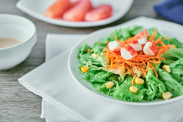 close up tight shot salad with carrots corn and shrimp bits with pomelo