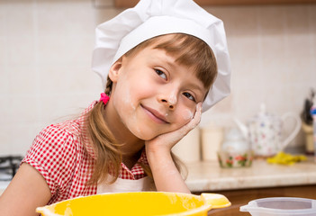 Little girl in a cook hat close up