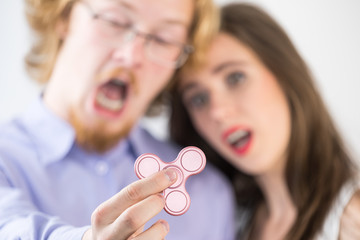 Couple playing with fidget spinner