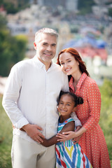 Girl feeling happy spending time with parents in summer