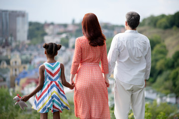 Family standing and enjoying amazing city view while walking