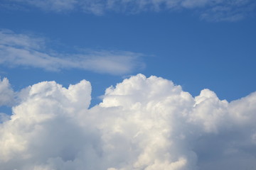 Fototapeta na wymiar Weiße Wolken türmen sich in den blauen Himmel - Regenwolken