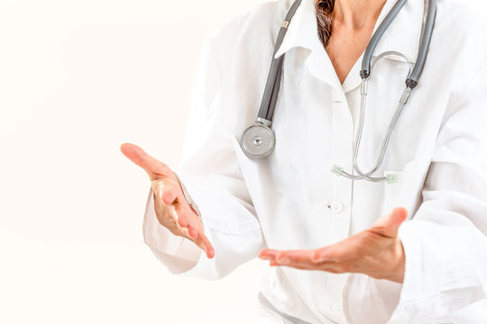 Female Doctor Explaining Patient Symptoms Or Asking A Question As They Discuss Together In A Consultation.