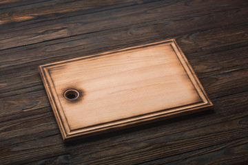 Cutting board on a wooden table. Kitchen, cooking