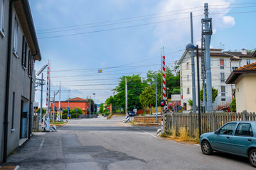 Monselice, Italy - July, 14, 2019: railroad crossing with automatic gates in Monselice, Italy