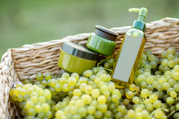 Jars and bottles with cosmetics or various health products made on the basis of grapes, packaging with copy space