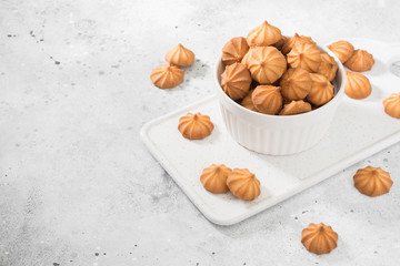 Butter cookies in a white vase on a light gray background