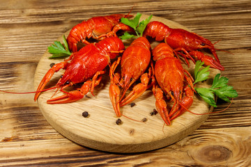 Boiled crayfish on cutting board on wooden table