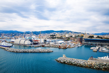Naklejka na ściany i meble View of Genoa Genova city and port harbor with sea view and yachts, ships. Liguria region of Italy. On cloudy day from high angle