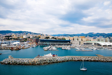 Fototapeta na wymiar View of Genoa Genova city and port harbor with sea view and yachts, ships. Liguria region of Italy. On cloudy day from high angle