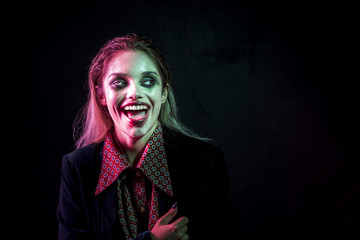 Woman dressed as joker laughing hysterically
