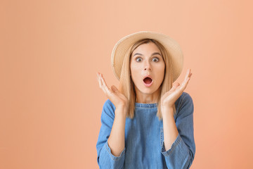 Shocked beautiful woman on color background