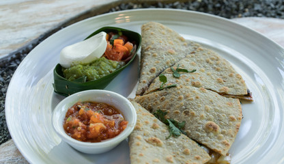 Vegan tortilla wrap, with vegetabes on a wooden background