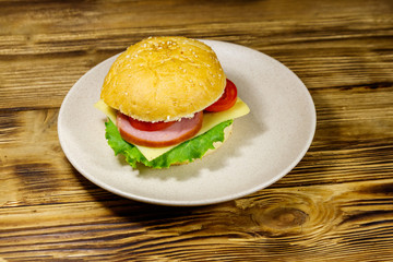 Fresh delicious homemade cheeseburger on wooden table