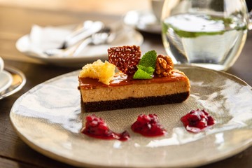 Maroon dessert with caramel and chocolate on plate.