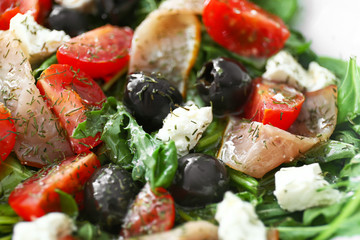 Tasty salad with meat, vegetables and olives, closeup