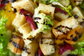 Tasty salad with vegetables and dried breads, closeup
