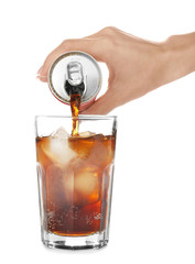Woman pouring cola into glass on white background