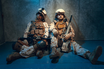 Fototapeta premium Two well equipped US army commandos armed with assault rifles. Studio shot