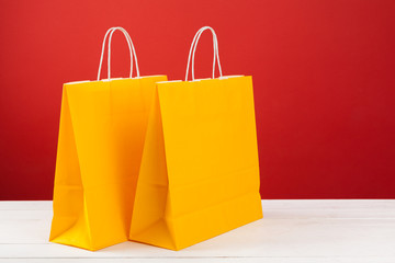 Paper shopping bags with copy space on red background