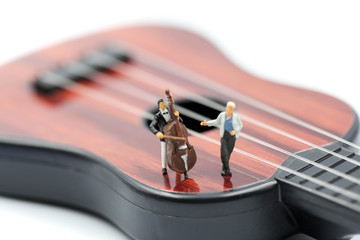 Miniature people : pianist playing piano and Violinist Man,playing musical instrument concept.