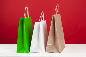 Several shopping bags with copy space on red background