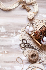 Time to wrap christmas presents! Ideas for hand made gifts decoration in rustic style, natural ingredients, cozy mood. Wooden background, scissors, rope, lace, cotton. Flat lay, copy space for text