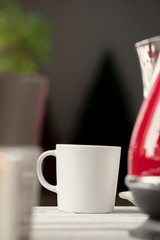 White porcelain cup on kitchen counter close up