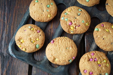 Homemade cookies on the grill of the oven. Dark wooden background