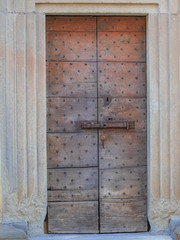 antique wooden entrance door with metal studs