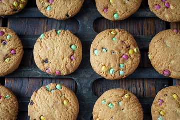 Homemade cookies on the grill of the oven. Dark wooden background