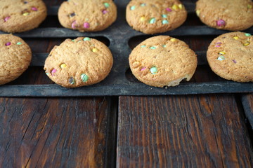 Obraz na płótnie Canvas Homemade cookies on the grill of the oven. Dark wooden background