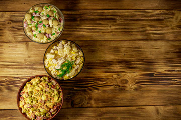 Obraz na płótnie Canvas Set of festive mayonnaise salads on wooden table. Top view, copy space
