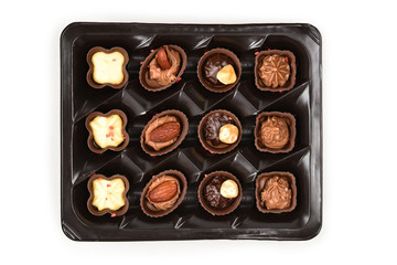Chocolate candy collection in plastic box.
