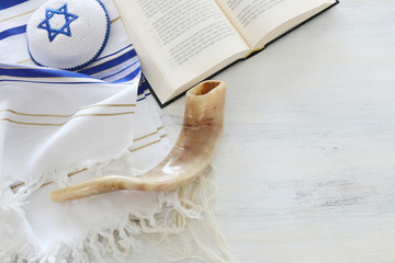 Fototapeta na wymiar religion image of Prayer Shawl - Tallit, Prayer book and Shofar (horn) jewish religious symbols. Rosh hashanah (jewish New Year holiday), Shabbat and Yom kippur concept.