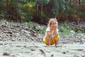 child playing on the sand