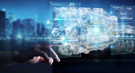 Businessman using wireframe holographic 3D digital projection of an engine