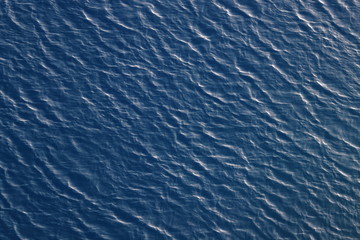 the turbulent surface of the sea as a backdrop