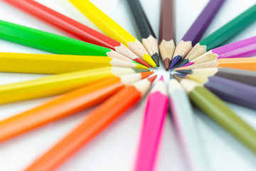 Many different colored pencils on white background