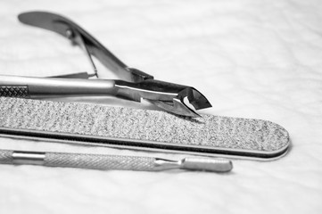 Manicure tools - photo, grayscale. Nail file, forceps.